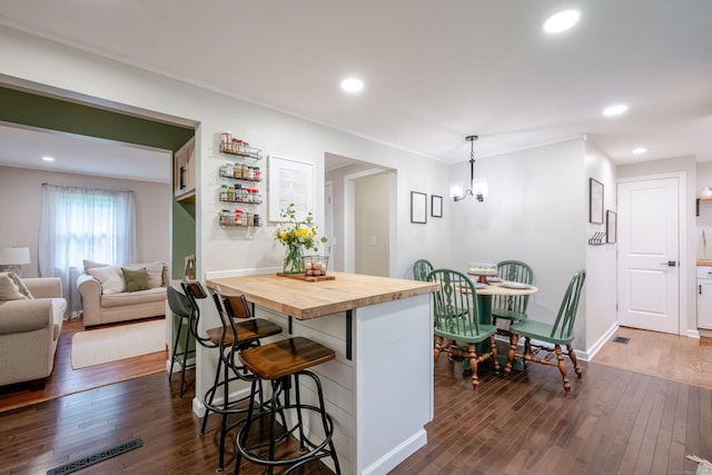 81 Burwell Rd, New Hartford, CT 06057 - kitchen featuring butcher block countertops, a kitchen breakfast bar, dark wood-type flooring, recessed lighting, and a chandelier