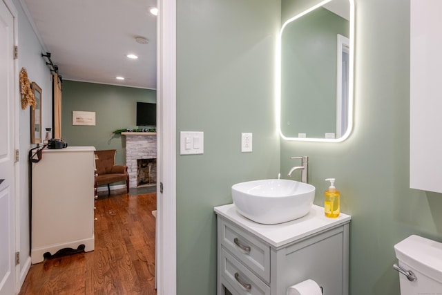 81 Burwell Rd, New Hartford, CT 06057 - bathroom featuring wood finished floors, vanity, recessed lighting, and a fireplace