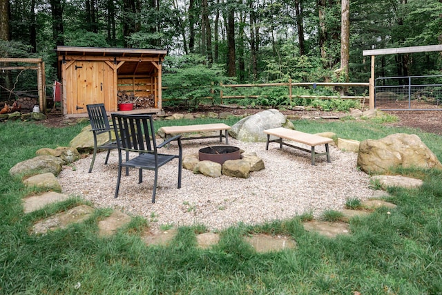 81 Burwell Rd, New Hartford, CT 06057 - view of patio featuring a fire pit and a storage unit