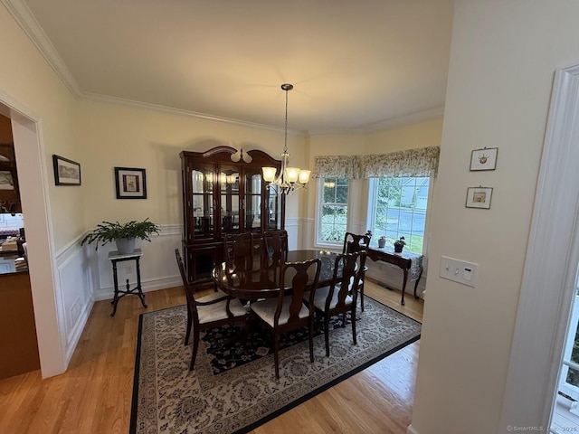25 Quarry Ln Unit 25, Berlin, CT 06037 - dining area with a chandelier, light wood-type flooring, crown molding, and a wainscoted wall