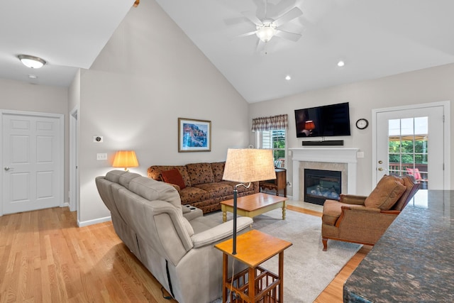 25 Quarry Ln Unit 25, Berlin, CT 06037 - living room featuring light wood finished floors, plenty of natural light, a ceiling fan, a glass covered fireplace, and high vaulted ceiling