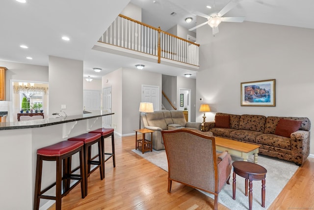 25 Quarry Ln Unit 25, Berlin, CT 06037 - living room with light wood-type flooring, a ceiling fan, recessed lighting, stairway, and a high ceiling