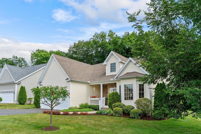 25 Quarry Ln Unit 25, Berlin, CT 06037 - traditional home with an attached garage, asphalt driveway, a front lawn, and a shingled roof