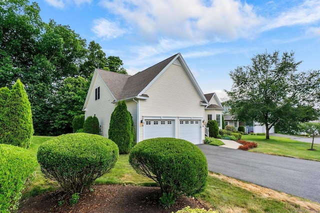 25 Quarry Ln Unit 25, Berlin, CT 06037 - view of home's exterior with asphalt driveway, a yard, and roof with shingles