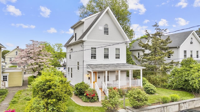 14 Jefferson St, Norwalk, CT 06851 - rear view of property featuring covered porch and a yard