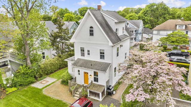 14 Jefferson St, Norwalk, CT 06851 - view of front of property with a shingled roof, a chimney, and a front lawn