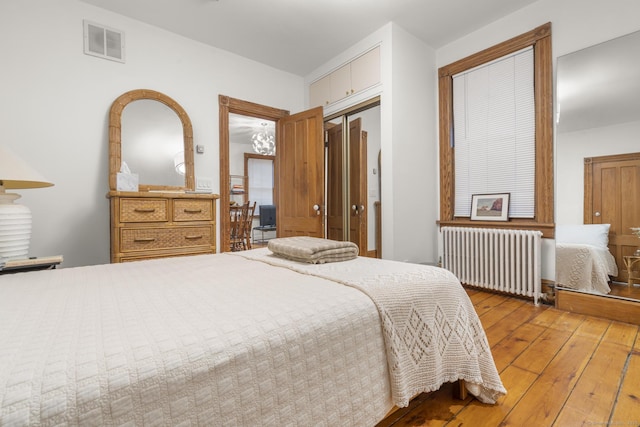 14 Jefferson St, Norwalk, CT 06851 - bedroom with radiator heating unit, wood-type flooring, and a closet