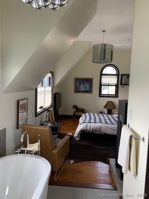 14 Jefferson St, Norwalk, CT 06851 - bedroom with multiple windows, a chandelier, wood finished floors, and vaulted ceiling