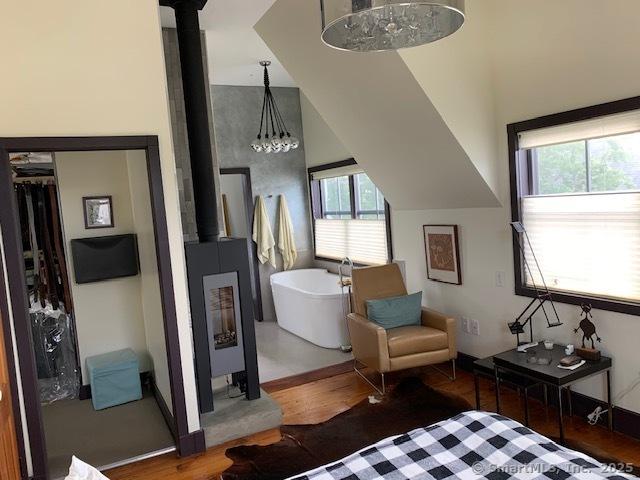 14 Jefferson St, Norwalk, CT 06851 - bedroom featuring wood finished floors and a wood stove