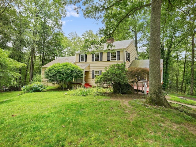 11 Dundee Rd, Stamford, CT 06903 - colonial house with a front lawn, a chimney, and a wooden deck
