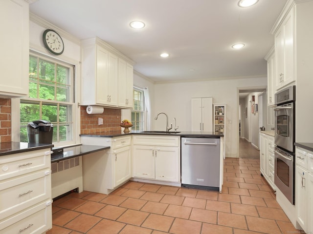 11 Dundee Rd, Stamford, CT 06903 - kitchen with stainless steel appliances, radiator, dark countertops, recessed lighting, and crown molding