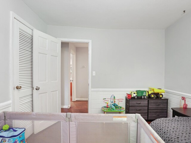 11 Dundee Rd, Stamford, CT 06903 - bedroom featuring a wainscoted wall and wood finished floors