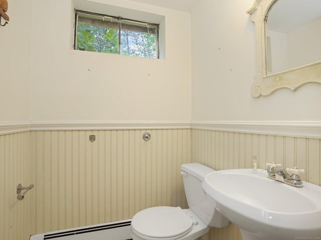11 Dundee Rd, Stamford, CT 06903 - half bathroom with a baseboard radiator and a wainscoted wall