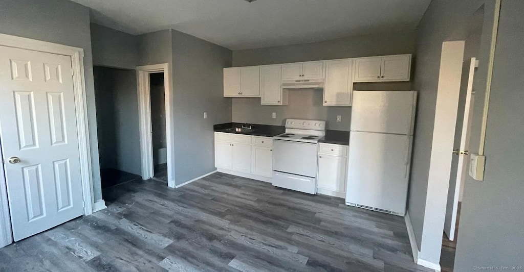 152 Brook St, Hartford, CT 06120 - kitchen with white appliances, under cabinet range hood, white cabinetry, dark wood-style flooring, and dark countertops