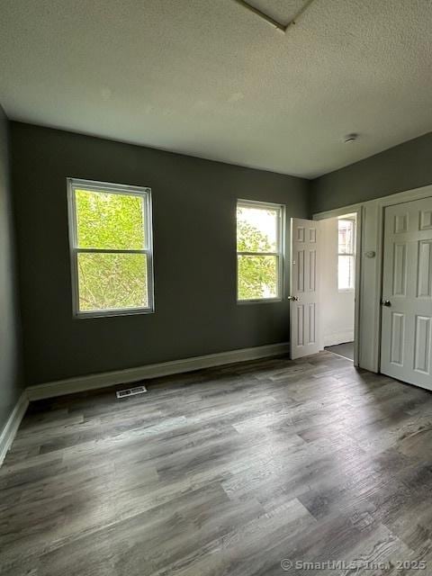 152 Brook St, Hartford, CT 06120 - unfurnished bedroom with wood finished floors and a textured ceiling