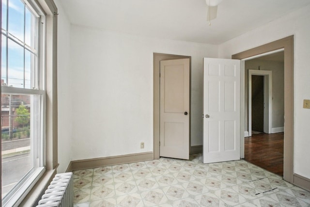 67 Whiting St, New Britain, CT 06051 - unfurnished room featuring radiator, plenty of natural light, light flooring, and a ceiling fan