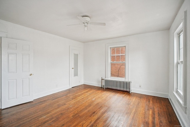 67 Whiting St, New Britain, CT 06051 - empty room featuring radiator, plenty of natural light, and wood-type flooring