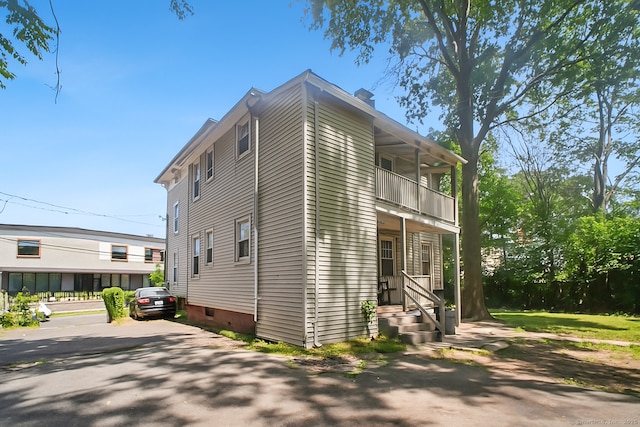 67 Whiting St, New Britain, CT 06051 - view of side of home with a balcony, crawl space, and a chimney