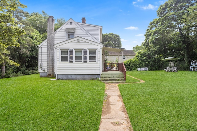 21 Harbor View Ave, Waterford, CT 06385 - back of property with a chimney and a lawn