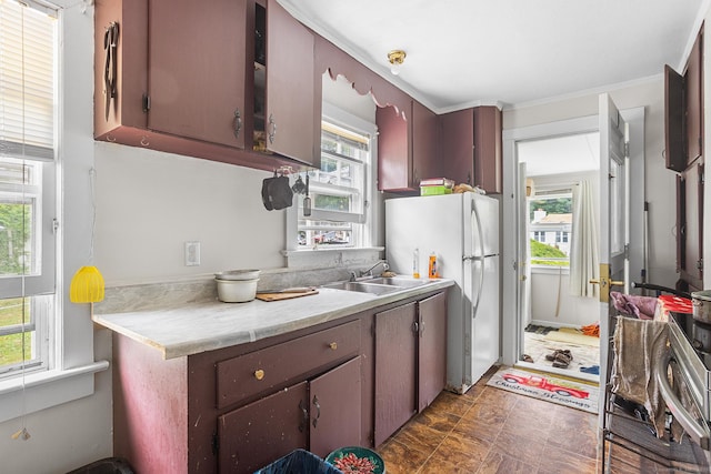 21 Harbor View Ave, Waterford, CT 06385 - kitchen with freestanding refrigerator, light countertops, plenty of natural light, and crown molding