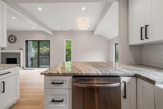 900 Heritage Vlg Unit B, Southbury, CT 06488 - kitchen with stainless steel dishwasher, healthy amount of natural light, beam ceiling, light stone countertops, and tasteful backsplash