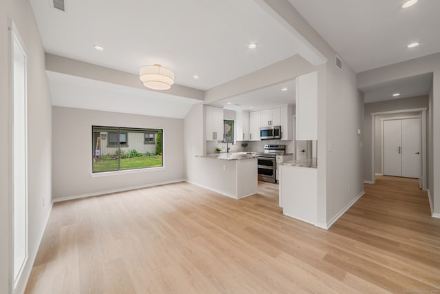 900 Heritage Vlg Unit B, Southbury, CT 06488 - kitchen featuring stainless steel appliances, white cabinets, a peninsula, light wood finished floors, and open floor plan
