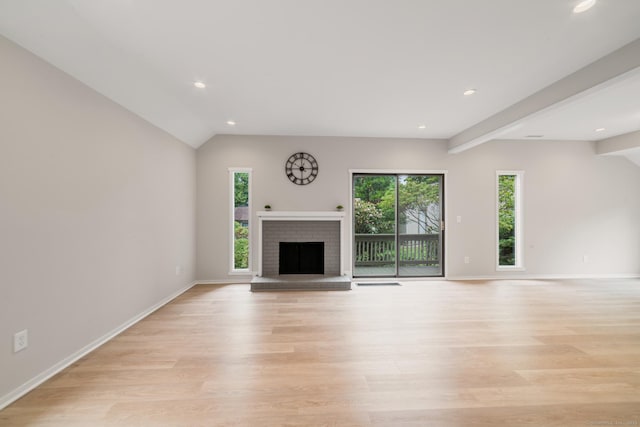 900 Heritage Vlg Unit B, Southbury, CT 06488 - unfurnished living room featuring a brick fireplace, light wood-style floors, lofted ceiling, and recessed lighting