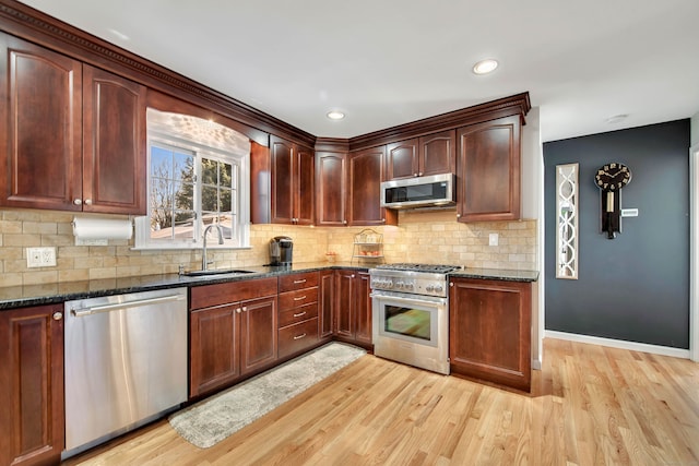 9 Anton Ln, Berlin, CT 06037 - kitchen featuring stainless steel appliances, dark stone counters, light wood-type flooring, and recessed lighting
