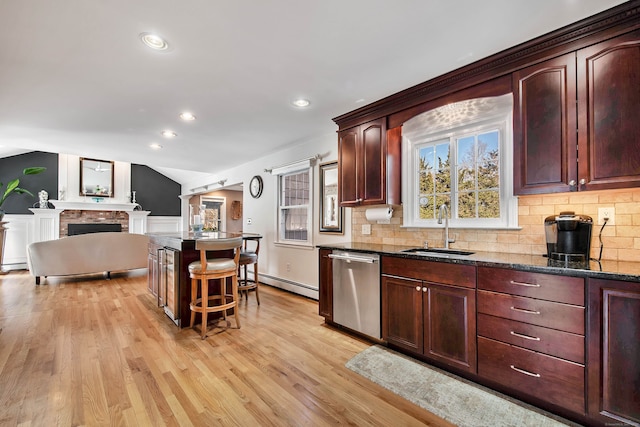 9 Anton Ln, Berlin, CT 06037 - kitchen with stainless steel dishwasher, a baseboard heating unit, a kitchen breakfast bar, tasteful backsplash, and vaulted ceiling