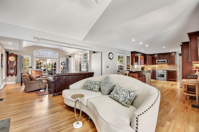 9 Anton Ln, Berlin, CT 06037 - living room featuring light wood-style flooring, lofted ceiling, recessed lighting, and a baseboard radiator