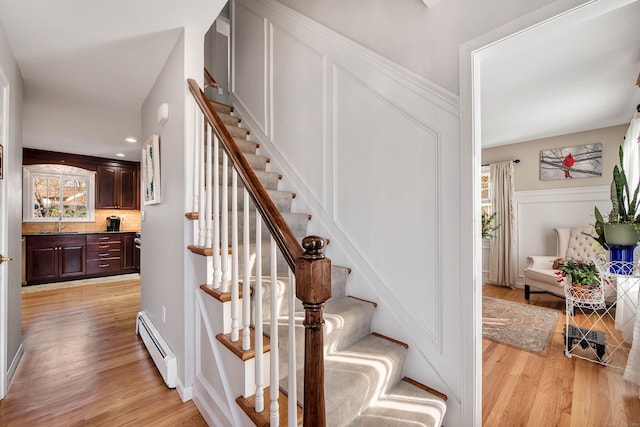 9 Anton Ln, Berlin, CT 06037 - stairway featuring baseboard heating, wood finished floors, and healthy amount of natural light