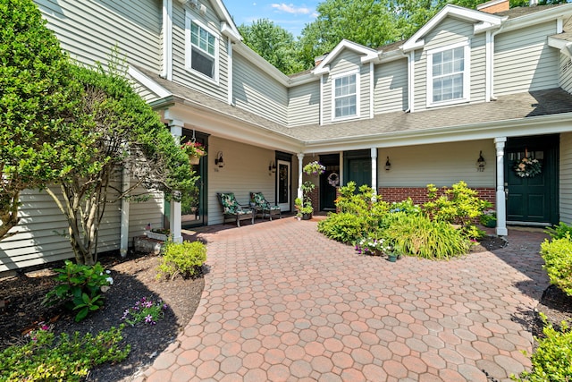 306 Hadley Dr Unit 306, Trumbull, CT 06611 - view of front of home featuring a porch, brick siding, and roof with shingles