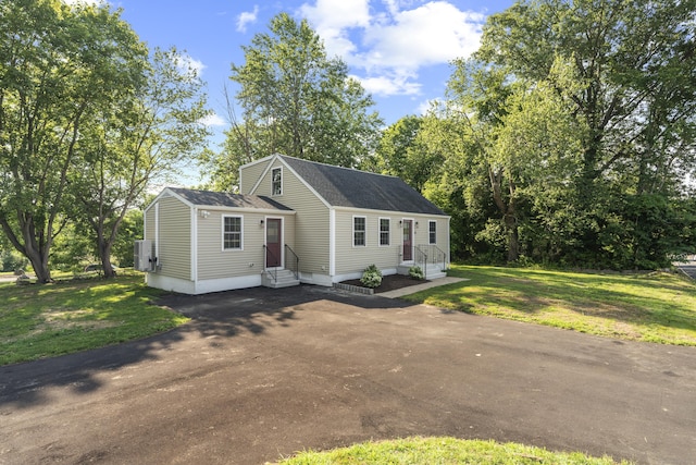 13 Brushy Plain Rd, Branford, CT 06405 - view of front of home featuring entry steps, roof with shingles, a front yard, and driveway