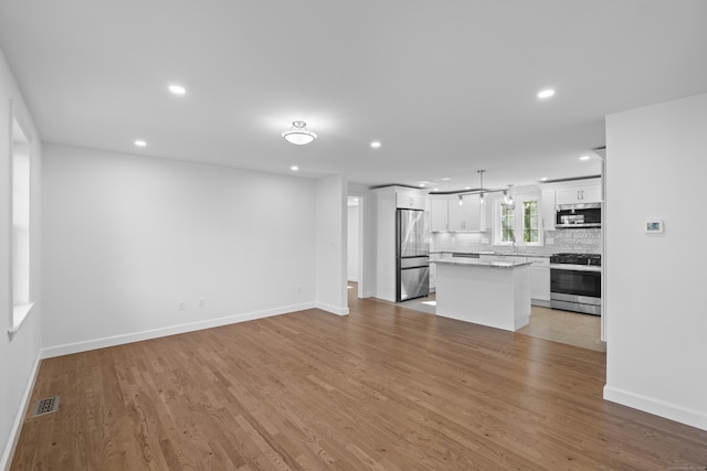 13 Brushy Plain Rd, Branford, CT 06405 - unfurnished living room featuring light wood-style flooring and recessed lighting