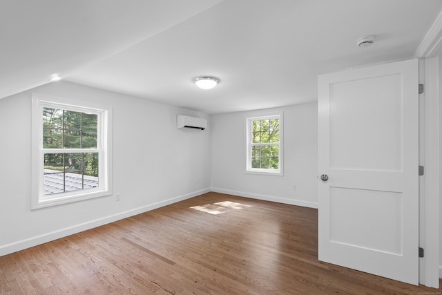 13 Brushy Plain Rd, Branford, CT 06405 - unfurnished bedroom with a wall unit AC, wood finished floors, and lofted ceiling