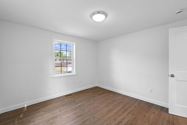 13 Brushy Plain Rd, Branford, CT 06405 - empty room with a smoke detector and wood finished floors