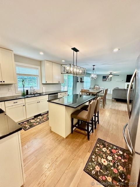 7 Pimlico Rd, Wolcott, CT 06716 - kitchen with appliances with stainless steel finishes, dark countertops, light wood finished floors, plenty of natural light, and recessed lighting