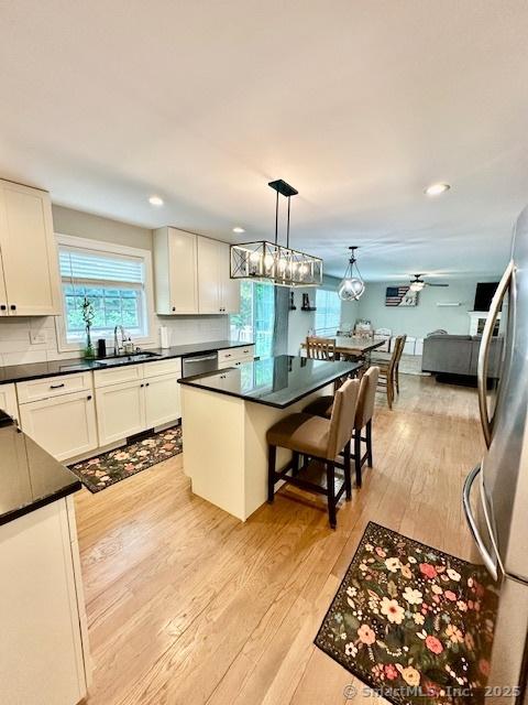7 Pimlico Rd, Wolcott, CT 06716 - kitchen featuring light wood-style flooring, dark countertops, stainless steel appliances, white cabinetry, and recessed lighting