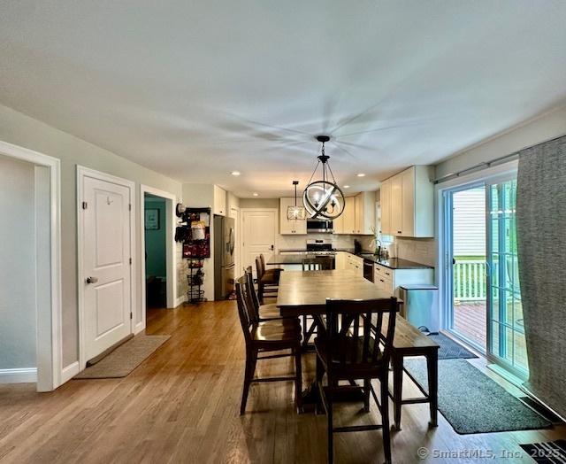 7 Pimlico Rd, Wolcott, CT 06716 - dining room with dark wood-style flooring, a chandelier, and recessed lighting