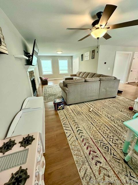 7 Pimlico Rd, Wolcott, CT 06716 - living area with ceiling fan, wood finished floors, and a fireplace