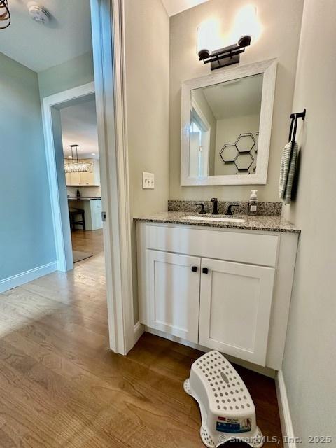 7 Pimlico Rd, Wolcott, CT 06716 - bathroom featuring vanity, wood finished floors, and a chandelier