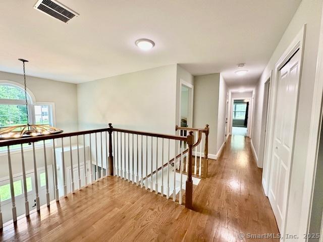 7 Pimlico Rd, Wolcott, CT 06716 - hall with wood finished floors and an upstairs landing