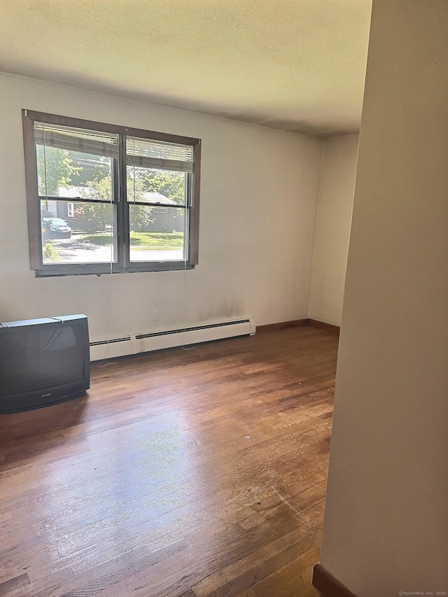 23 Westerly Dr, Enfield, CT 06082 - unfurnished room with a baseboard radiator, hardwood / wood-style flooring, healthy amount of natural light, and a textured ceiling