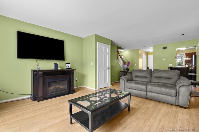 827 Oronoke Rd Apt 5-6, Waterbury, CT 06708 - living room featuring wood finished floors, stairs, and a glass covered fireplace