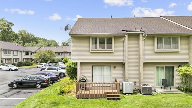 827 Oronoke Rd Apt 5-6, Waterbury, CT 06708 - rear view of house featuring uncovered parking, a yard, and roof with shingles