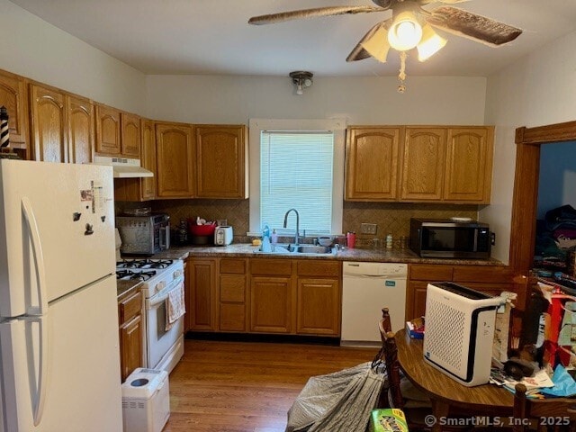 72 Stewart St, Bristol, CT 06010 - kitchen with white appliances, under cabinet range hood, decorative backsplash, wood finished floors, and a ceiling fan