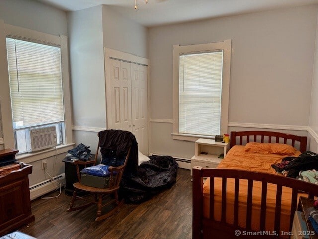 72 Stewart St, Bristol, CT 06010 - bedroom with a baseboard heating unit, dark wood-style floors, cooling unit, and a closet