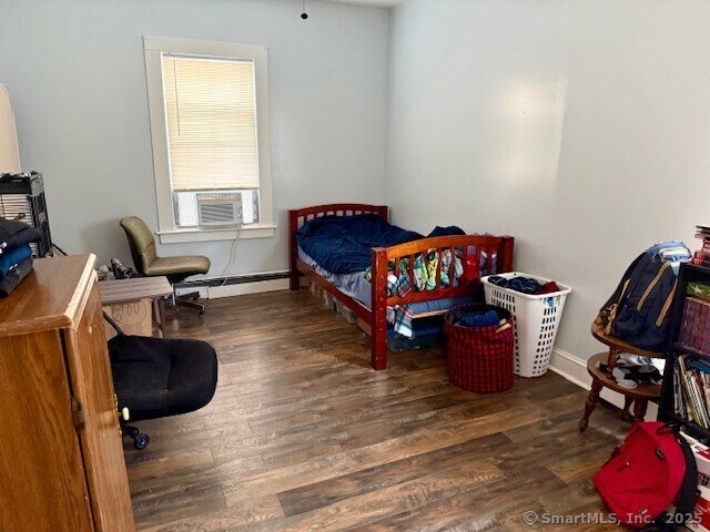 72 Stewart St, Bristol, CT 06010 - bedroom featuring wood finished floors, cooling unit, and baseboard heating