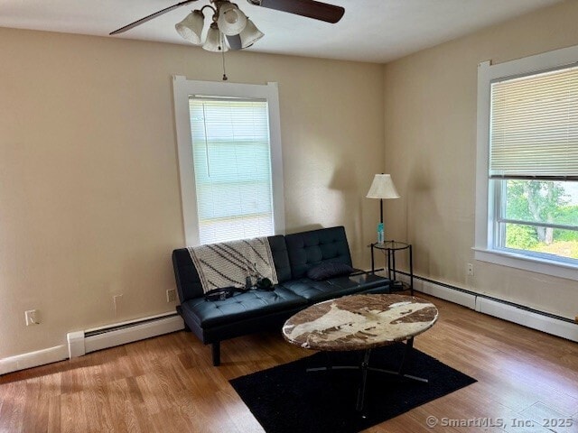 72 Stewart St, Bristol, CT 06010 - living room featuring baseboard heating, ceiling fan, and wood finished floors