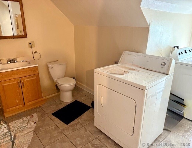 72 Stewart St, Bristol, CT 06010 - laundry area with independent washer and dryer and light tile patterned floors